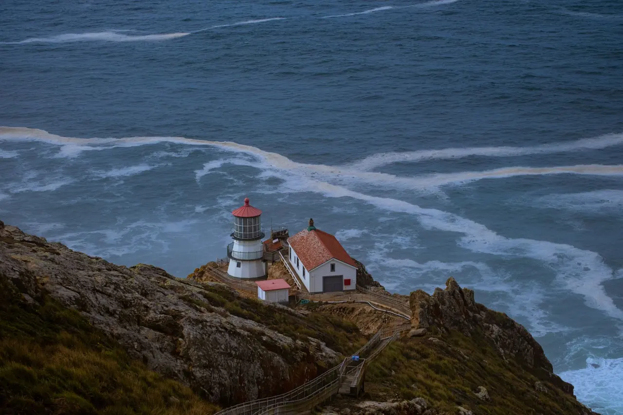 The Point Reyes lighthouse seen from above, waves breaking below